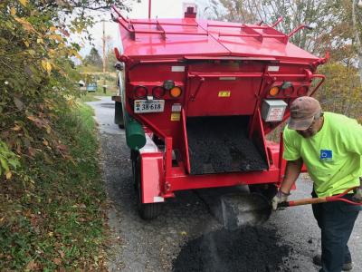 City employee using Hotbox to fill pothole